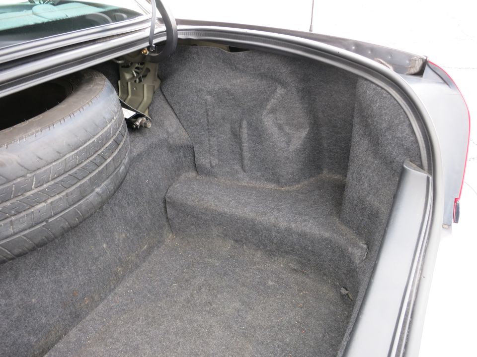 2001 Ford Crown Victoria trunk interior with spare tire mounted on left side