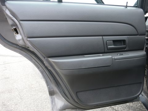 2001 Ford Crown Victoria - Interior door panel of a 2001 Ford Crown Victoria, a gray finish and standard door handle.