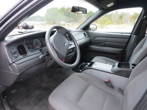 2001 Ford Crown Victoria - The interior of a 2001 Ford Crown Victoria is captured, highlighting the driver's side controls and passenger seating.