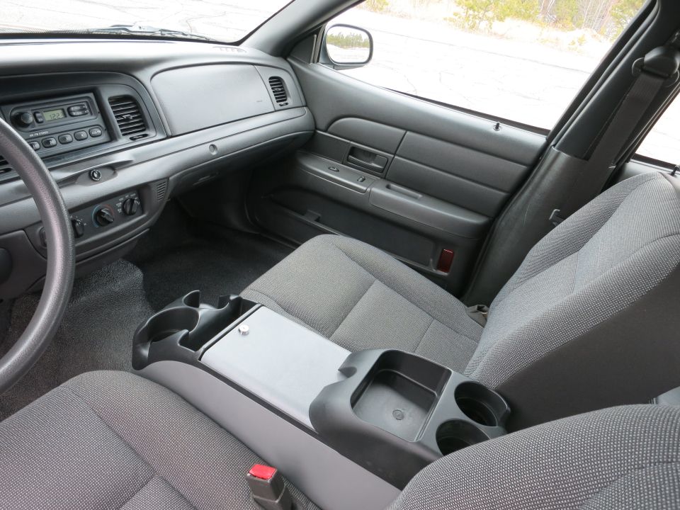 2001 Ford Crown Victoria interior showing front seats, center console with cup holders, and dashboard