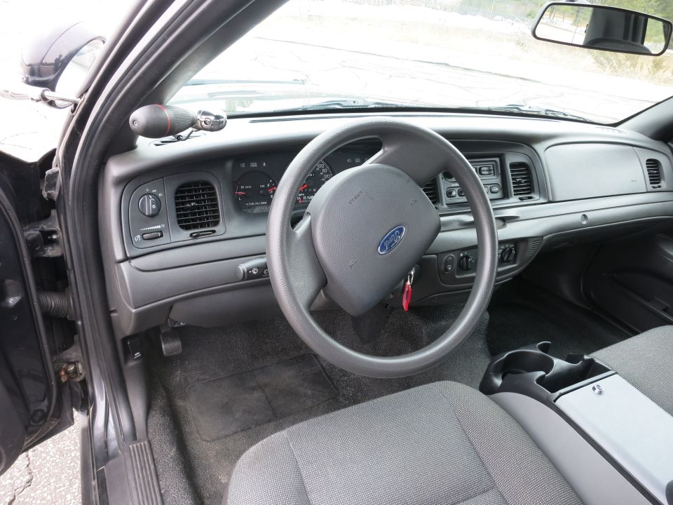 Interior of a 2001 Ford Crown Victoria showing the dashboard, steering wheel with Ford logo, and center console