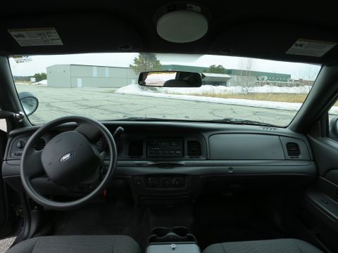 2001 Ford Crown Victoria - The interior of a 2001 Ford Crown Victoria is viewed from the passenger seat, looking towards the driver's side.