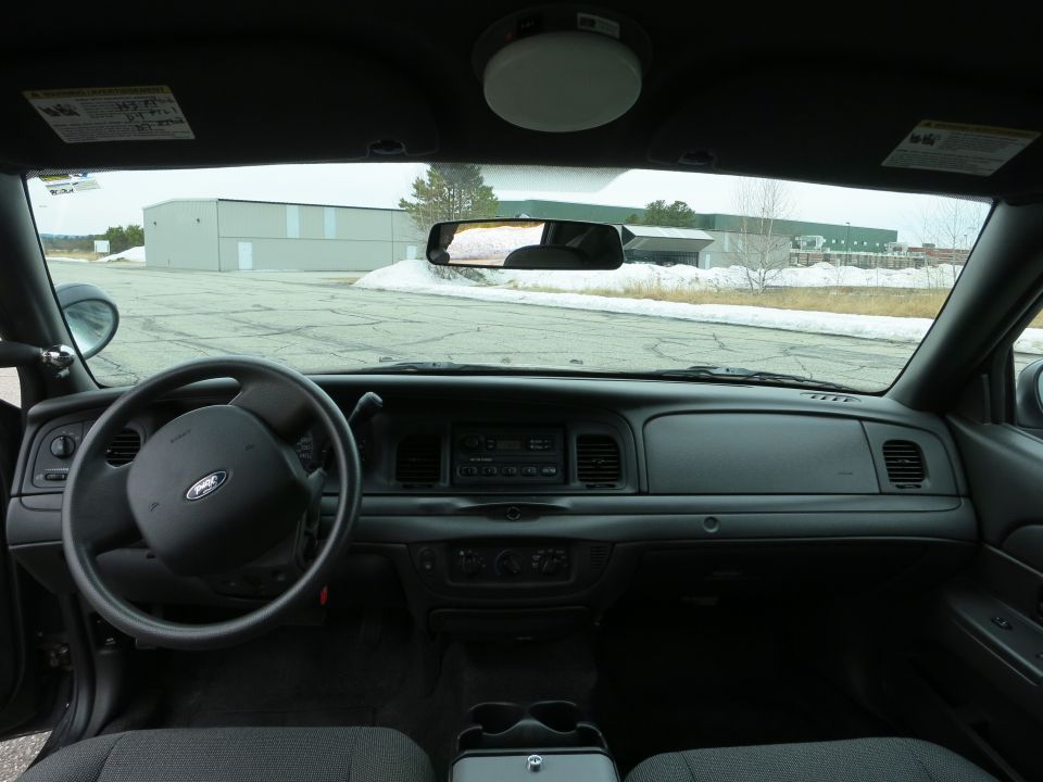 Interior of a 2001 Ford Crown Victoria showing the dashboard, steering wheel, and center console