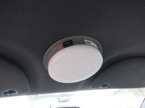 2001 Ford Crown Victoria - Close-up of a vehicle's interior dome light, an on/off switch and a red indicator light.