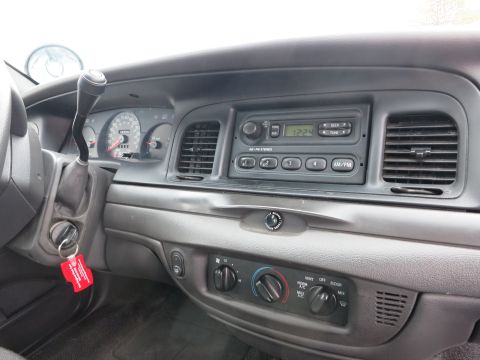 2001 Ford Crown Victoria - Interior view of a 2001 Ford Crown Victoria, showing the dashboard, radio, and instrument cluster.