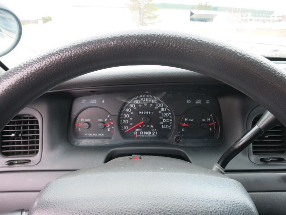 2001 Ford Crown Victoria interior showing dashboard gauges and steering wheel. Odometer reads 083561