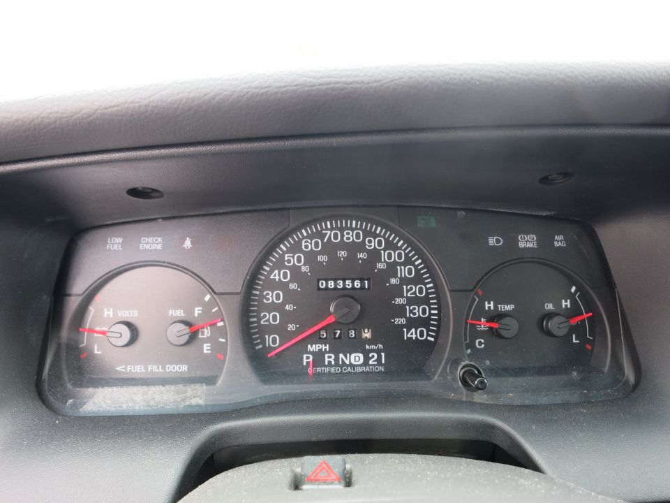 Dashboard gauges showing 83,561 miles, fuel level, oil, temperature, and gear selection