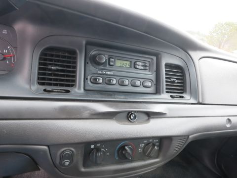 2001 Ford Crown Victoria - Interior view of a 2001 Ford Crown Victoria's dashboard, focusing on the center console with radio and HVAC controls.
