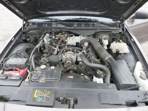 2001 Ford Crown Victoria - The engine bay of a 2001 Ford Crown Victoria, showing the engine components and a label with readable text.