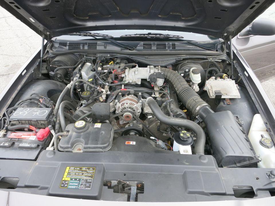 2001 Ford Crown Victoria engine bay with visible text on a label
