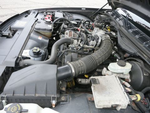 2001 Ford Crown Victoria - Close-up view of the engine compartment, showing various mechanical parts and wiring harnesses.