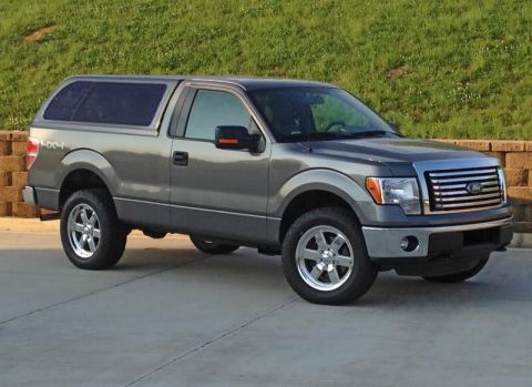 1994 Ford Bronco - This Ford F-150 truck features a distinctive grille and a camper shell, indicating a model year around 2009.