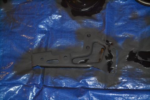 1981 Ford F-250 - A metal bracket is shown on a blue tarp, likely before installation or after cleaning.