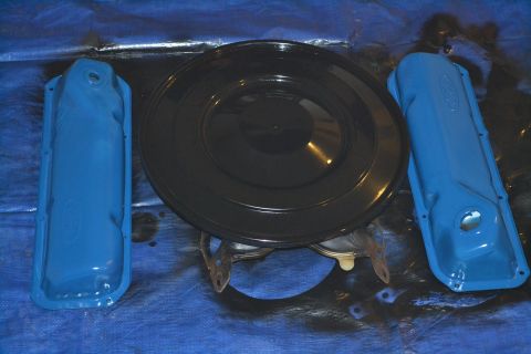 1981 Ford F-250 - Engine parts, including valve covers and an air cleaner, are laid out on a blue tarp.