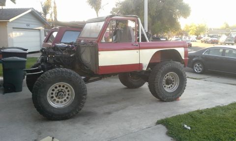 1968 Ford Bronco - This 1968 Ford Bronco is undergoing modifications with its engine visible and custom suspension.