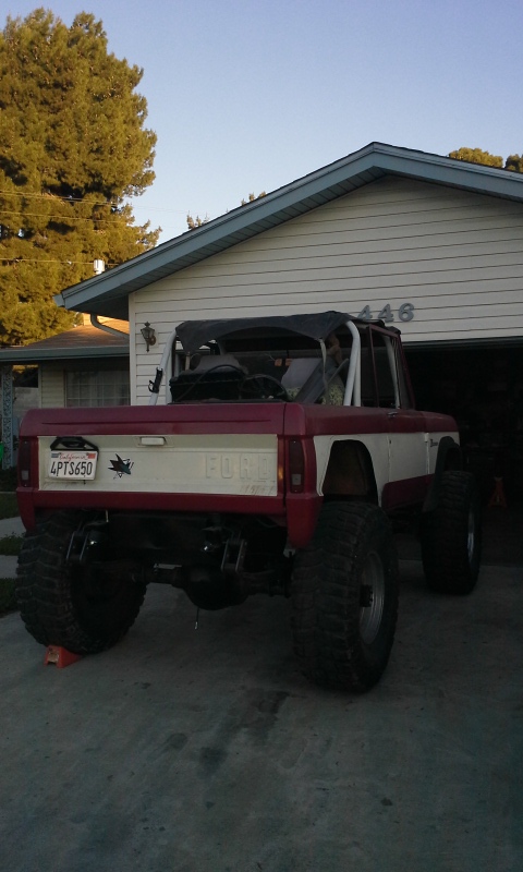 1968 Ford Bronco - This 1968 Ford Bronco is shown from a rear three-quarter view, parked in front of a residential garage.