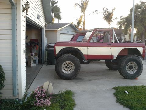 1968 Ford Bronco - Modified 1968 Ford Bronco in red and white, a lift kit and oversized tires.