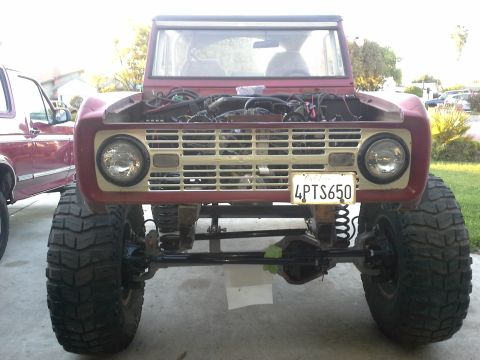 1968 Ford Bronco - Front view of a 1968 Ford Bronco with its hood open, revealing the engine compartment.