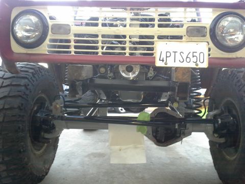 1968 Ford Bronco - Front view of a 1968 Ford Bronco, highlighting its lifted suspension and exposed engine components.