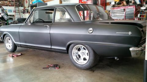 1963 Chevrolet Nova - Matte gray 1963 Chevrolet Nova in a garage, showing its 3q-front profile and custom wheels.