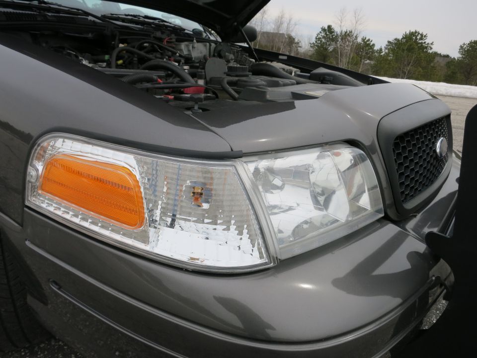 2001 Ford Crown Victoria front corner with hood open, showing engine detail
