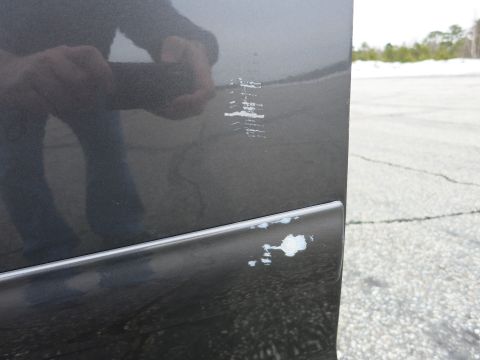2001 Ford Crown Victoria - Scratches and paint damage are visible on the side panel of a vehicle.