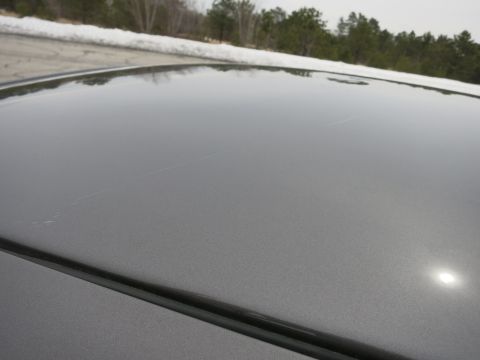 2001 Ford Crown Victoria - Close-up of a grey car roof showing minor scratches and reflections.