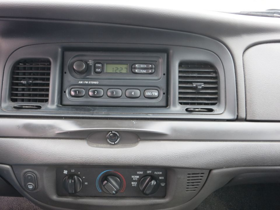 2001 Ford Crown Victoria dashboard showing AM/FM stereo, climate controls, and air vents