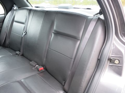 2001 Ford Crown Victoria - Interior view of the back seat of a car, showing the upholstery and seatbelts.