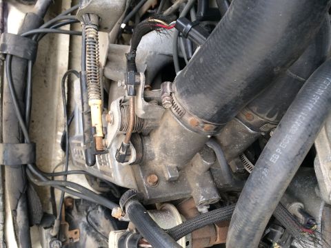 1991 Ford F-150 - This is a close-up view of the engine's throttle body and associated hoses and wiring.
