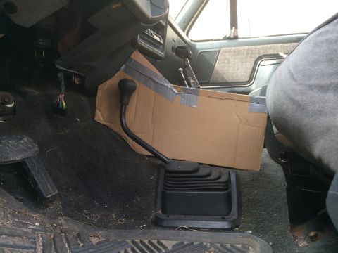 1991 Ford F-150 - A cardboard box has been taped over the center console of this truck, covering the gear shifter and part of the dashboard.