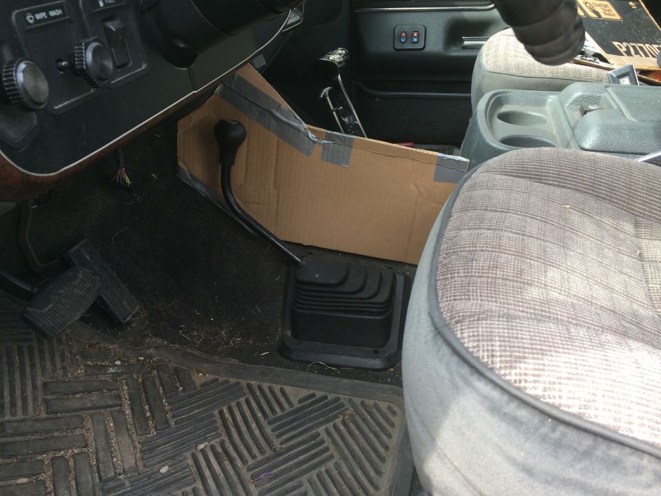 Truck interior with a cardboard console modification and a floor shifter