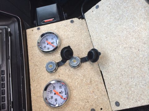 1991 Ford F-150 - Vehicle interior shows two gauges and two power outlets installed on a custom wood panel.