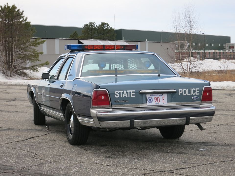 Massachusetts State Police Ford sedan, direct rear view with light bar