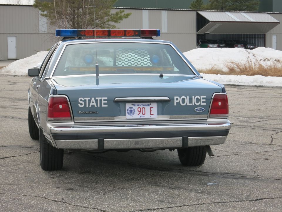 Direct rear view of blue Ford Crown Victoria State Police cruiser, Massachusetts plate