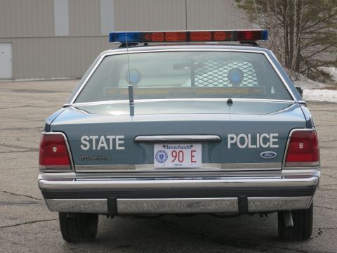 1991 Ford LTD Crown Victoria - Close direct rear view of a two-tone blue Ford LTD Crown Victoria marked STATE POLICE with Ford badge and Massachusetts plate.
