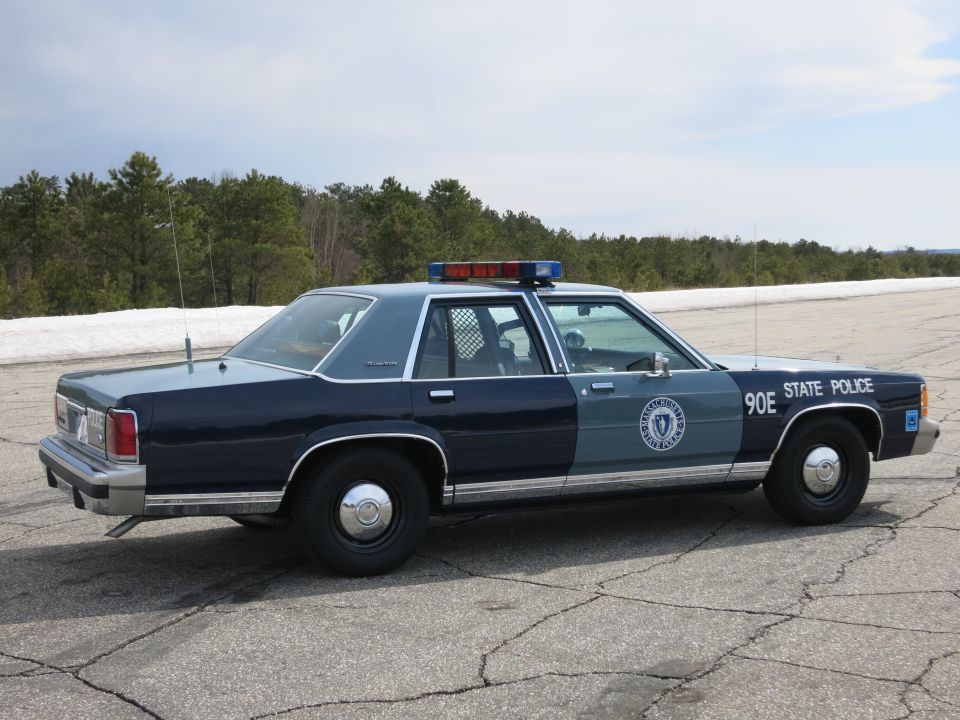 Massachusetts State Police cruiser 90E, rear three-quarter view, lightbar on roof