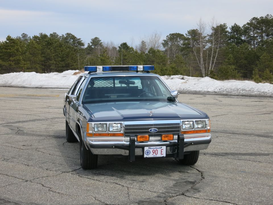 Front view of a Ford Massachusetts State Police sedan with bull bar and 90E plate