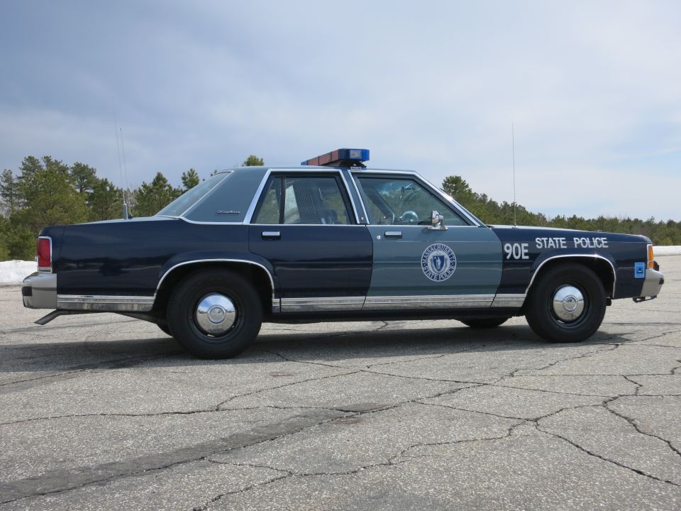Massachusetts State Police cruiser 90E, full side profile on pavement