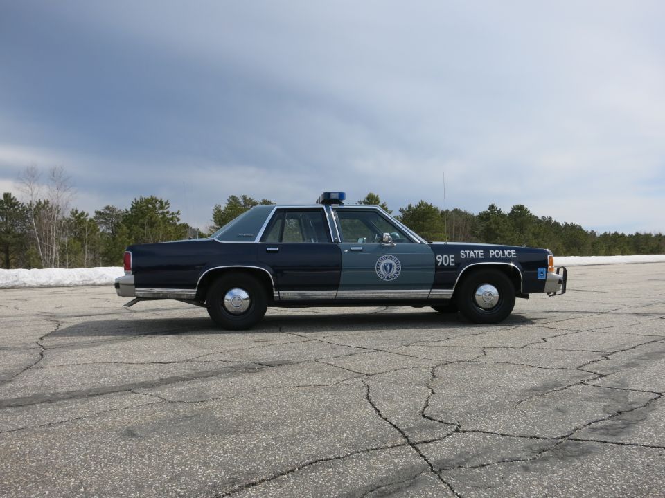 Massachusetts State Police sedan 90E, far-side profile in open lot