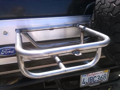 1992 Ford Bronco - Rear view of a 1992 Ford Bronco showing a custom metal bumper guard and spare tire mounted.