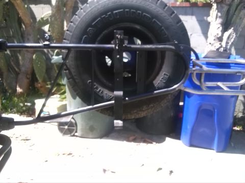 1992 Ford Bronco - A spare tire carrier is shown mounted to the rear of a vehicle, holding a Pathfinder tire.