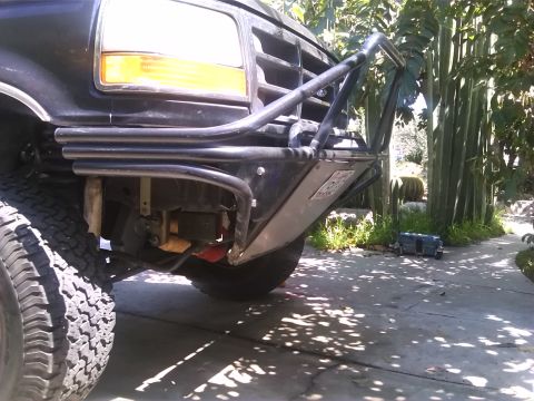 1992 Ford Bronco - Front view of a black 1992 Ford Bronco with a heavy-duty brush guard and custom bumper.