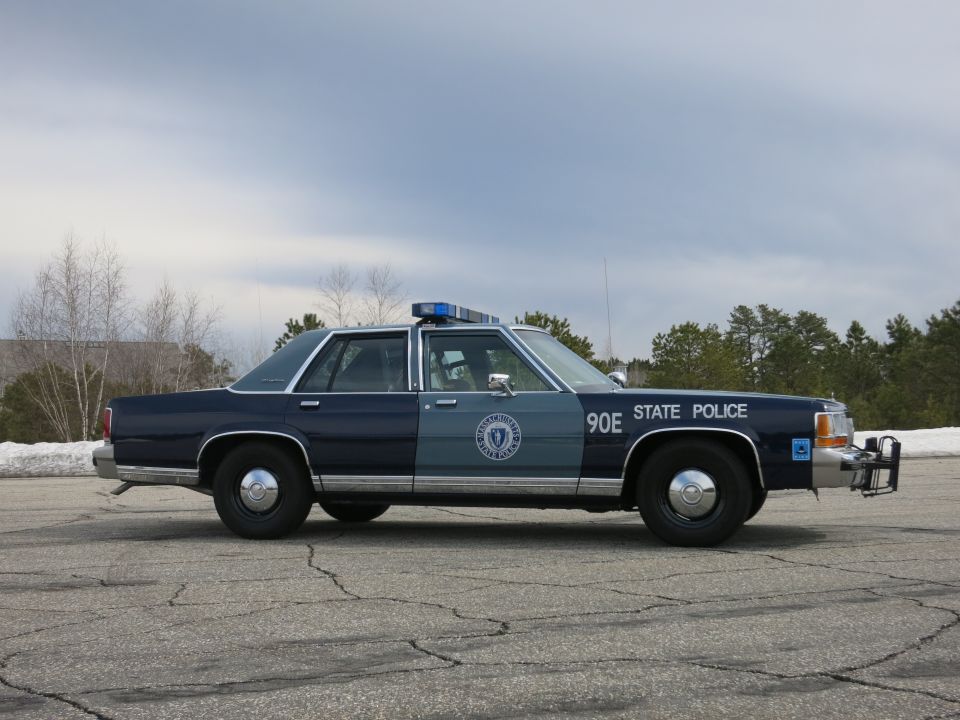 Massachusetts State Police sedan 90E, near-side profile with push bumper