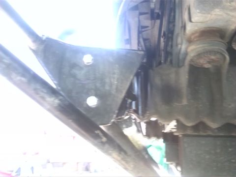 1992 Ford Bronco - Close-up view of a vehicle's undercarriage, showing mechanical parts and a website watermark.