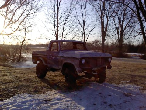 1978 Ford Bronco - This weathered 1970s Ford F-Series pickup truck sits in a snowy outdoor setting.
