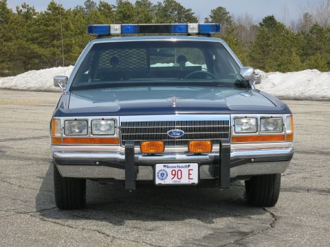 1991 Ford LTD Crown Victoria - two-tone blue Massachusetts State Police Ford LTD Crown Victoria viewed head-on with chrome grille and push bumper.