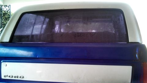 1979 Ford Bronco - The rear of a blue 1979 Ford Bronco shows its distinctive tailgate panel and two-tone paint scheme.