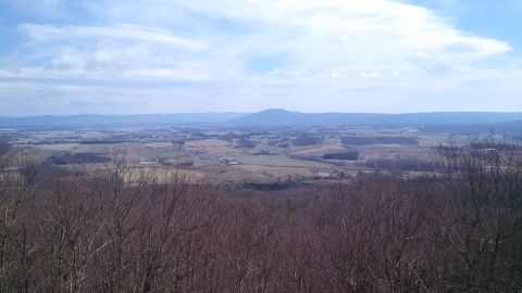 1979 Ford Bronco - Expansive rural landscape with mountains in the distance, viewed from a wooded overlook.