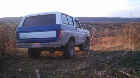 1979 Ford Bronco - Rear view of a 1979 Ford Bronco in a rural landscape.